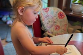 Tillie practicing writing a letter to Grandpa