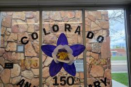 Columbine  made out of white paper and painted purple and yellow  wording printed from pinterest