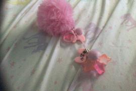Made Keychain at home, Pink with a fluffy pom pom on the top with pink video game controller charms, stars, and mini pale pink pom poms