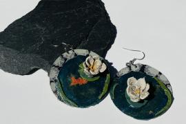Leather earrings that look like Lilly pads floating on the shore of a lake 