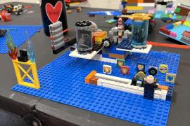 A Lego scene of a minifig in an arcade shooting range