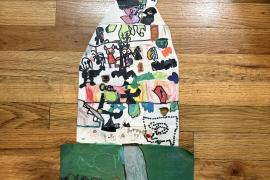 Large art project of a haunted house filled with monsters and a graveyard