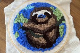 It is a punch-needle creation of a sloth