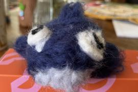 It is a needle-felted representation of a humpback whale.