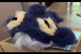 It is a needle-felted representation of a humpback whale.