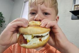 Clem eating breakfast sandwich