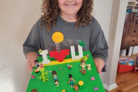 josie holding green lego tray