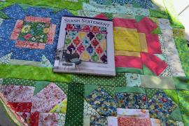 Colorful quilt with photo of a Denver Public Library quilting book from which the pattern was copied.