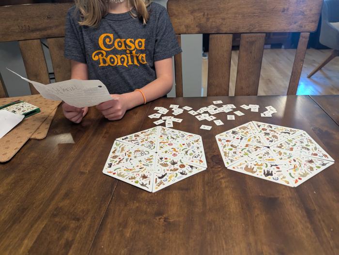 New game with creator holding the new written rules.