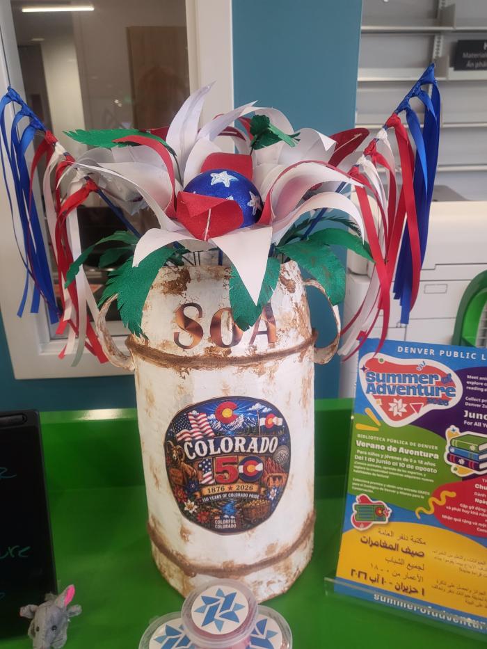 Jug was made out of cardboard flowers out of paper and painted red  center of the flowers styrofoam  from amazon packaging painted blue with white stars pictures are printed from pinterest and leave from white paper painted green.