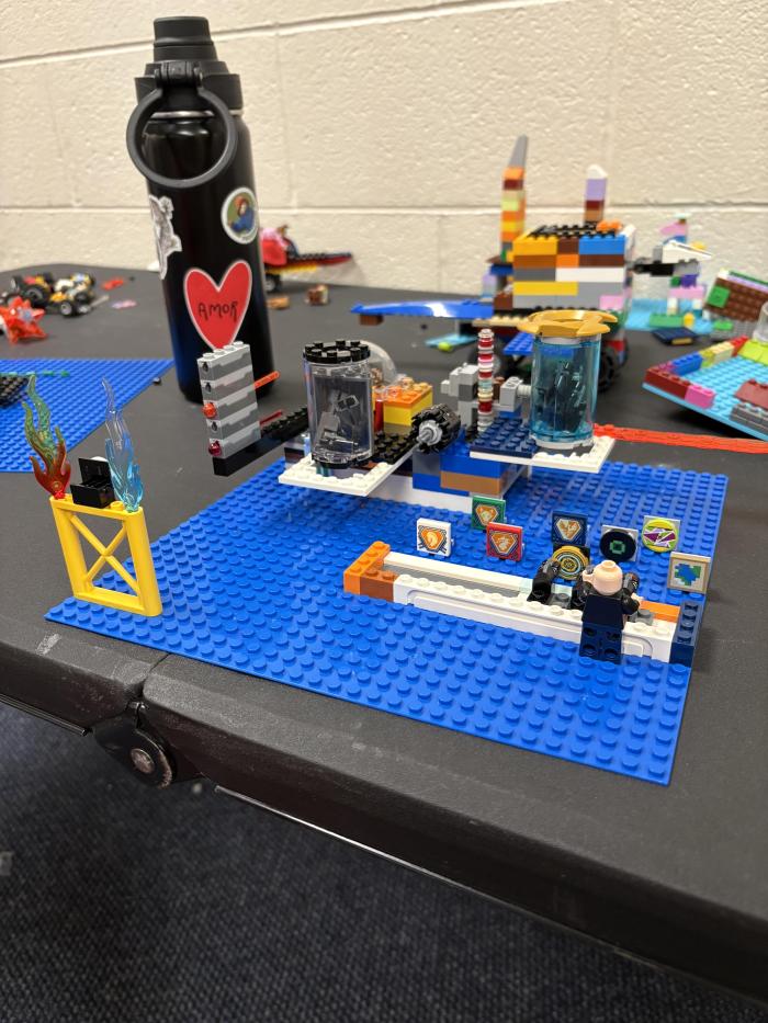 A Lego scene of a minifig in an arcade shooting range