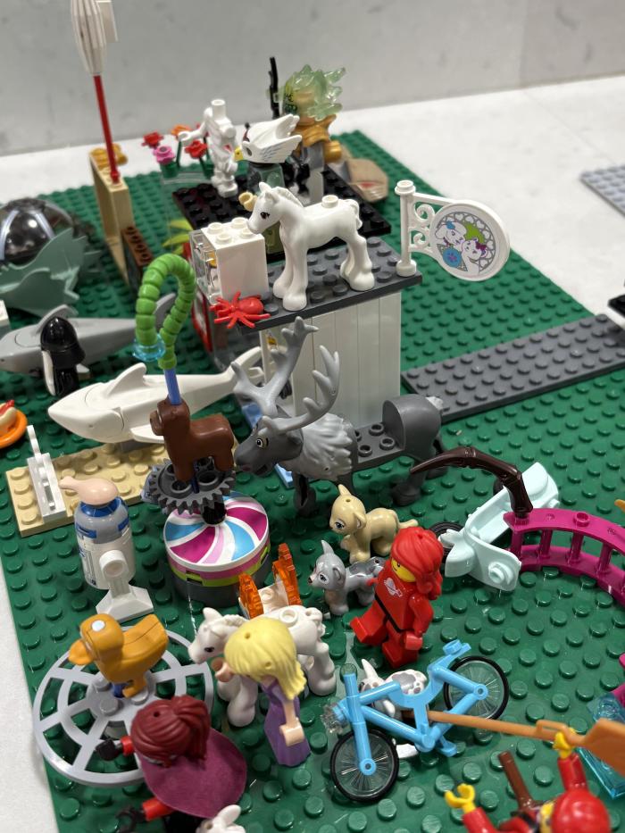 Lego creation of people and animals lined up in a scene. 