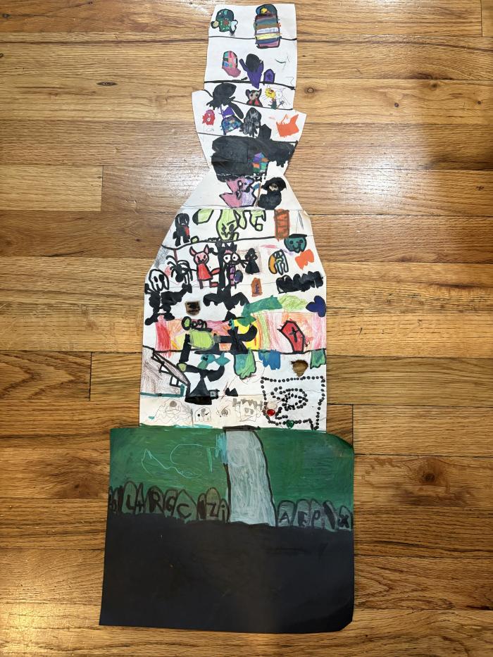 Large art project of a haunted house filled with monsters and a graveyard