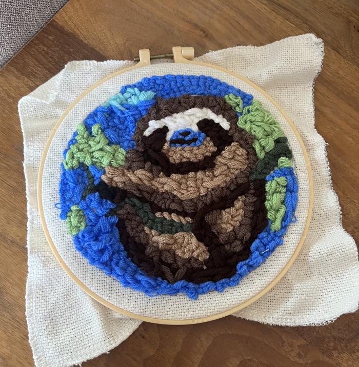 It is a punch-needle creation of a sloth