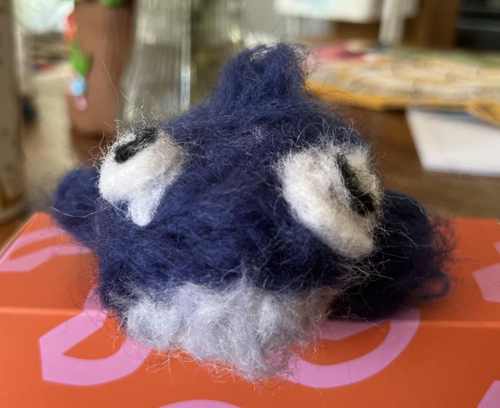 It is a needle-felted representation of a humpback whale.