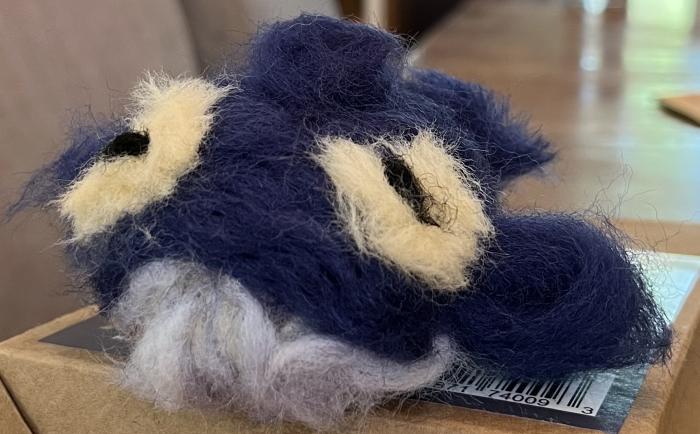 It is a needle-felted representation of a humpback whale.