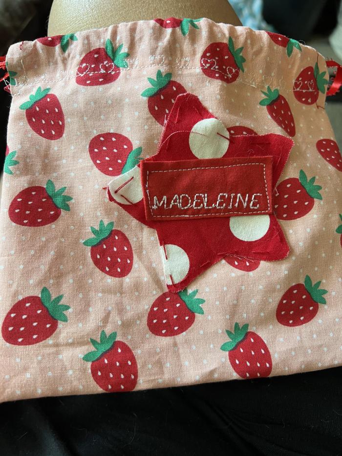 Used a sewing machine and picked out the cute strawberry fabric for summer