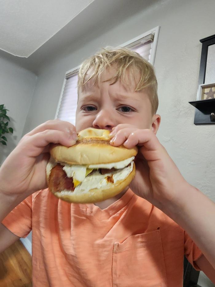 Clem eating breakfast sandwich