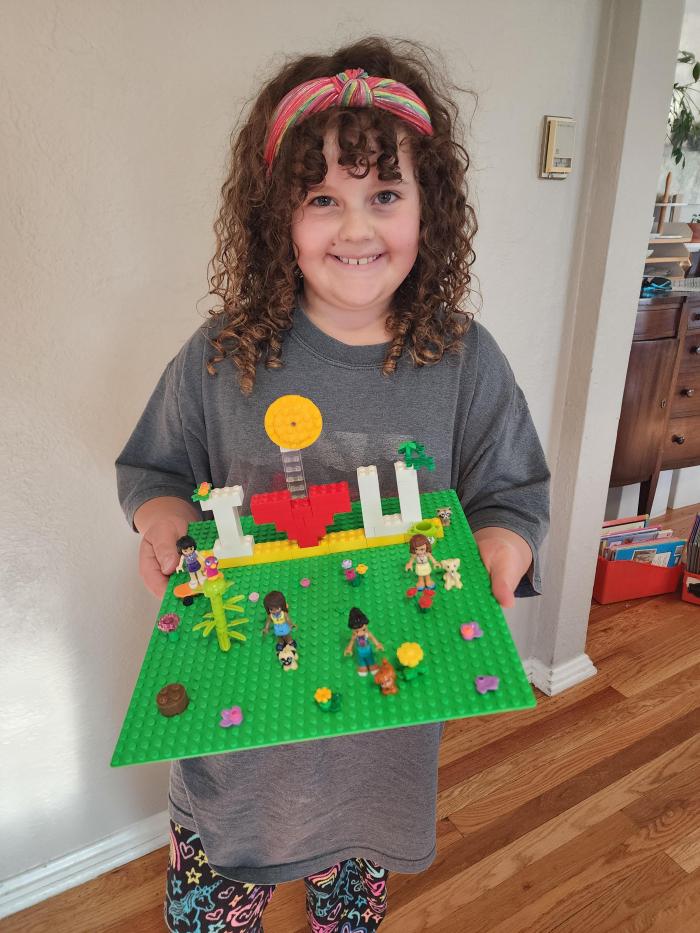 josie holding green lego tray