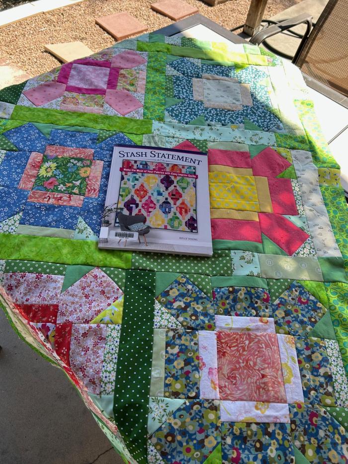 Colorful quilt with photo of a Denver Public Library quilting book from which the pattern was copied.